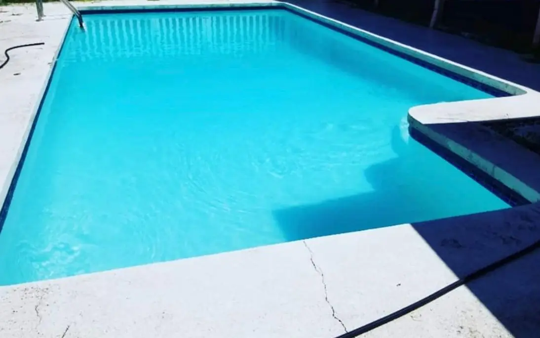 The same pool after service, with clear blue water